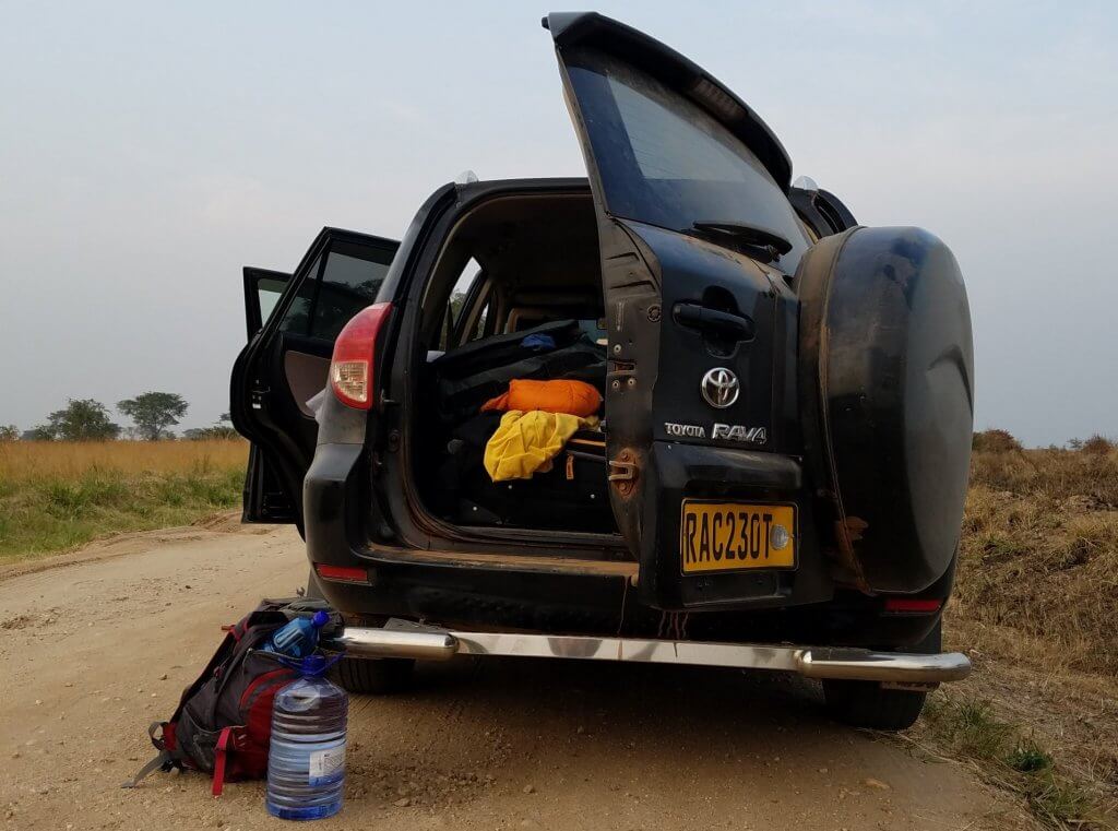 Our rental car, Apetimus Prime, broken down on the Uganda savanna.